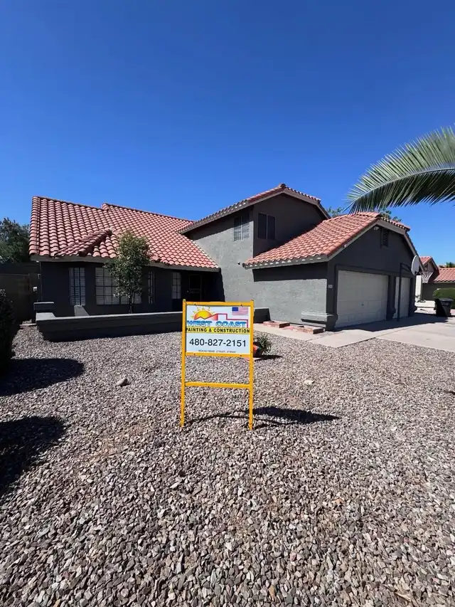 Gray stucco repaint, tile roof